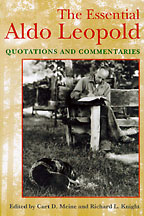 Cover of Meine and Knight's book features a photo of Aldo Leopold writing, sitting on a rough hewn bench, with a dog curled up at his feet.