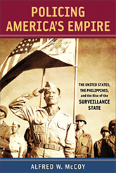 The cover of McCoy's book is deep red, dark blue, and a sepia white. The photo is of a several ranks of Philippine military troups. The man in front salutes, while an American flag flies overhead.