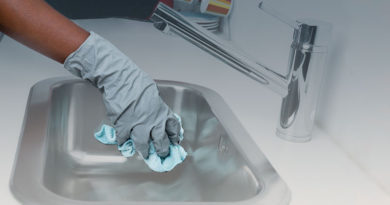person cleaning sink